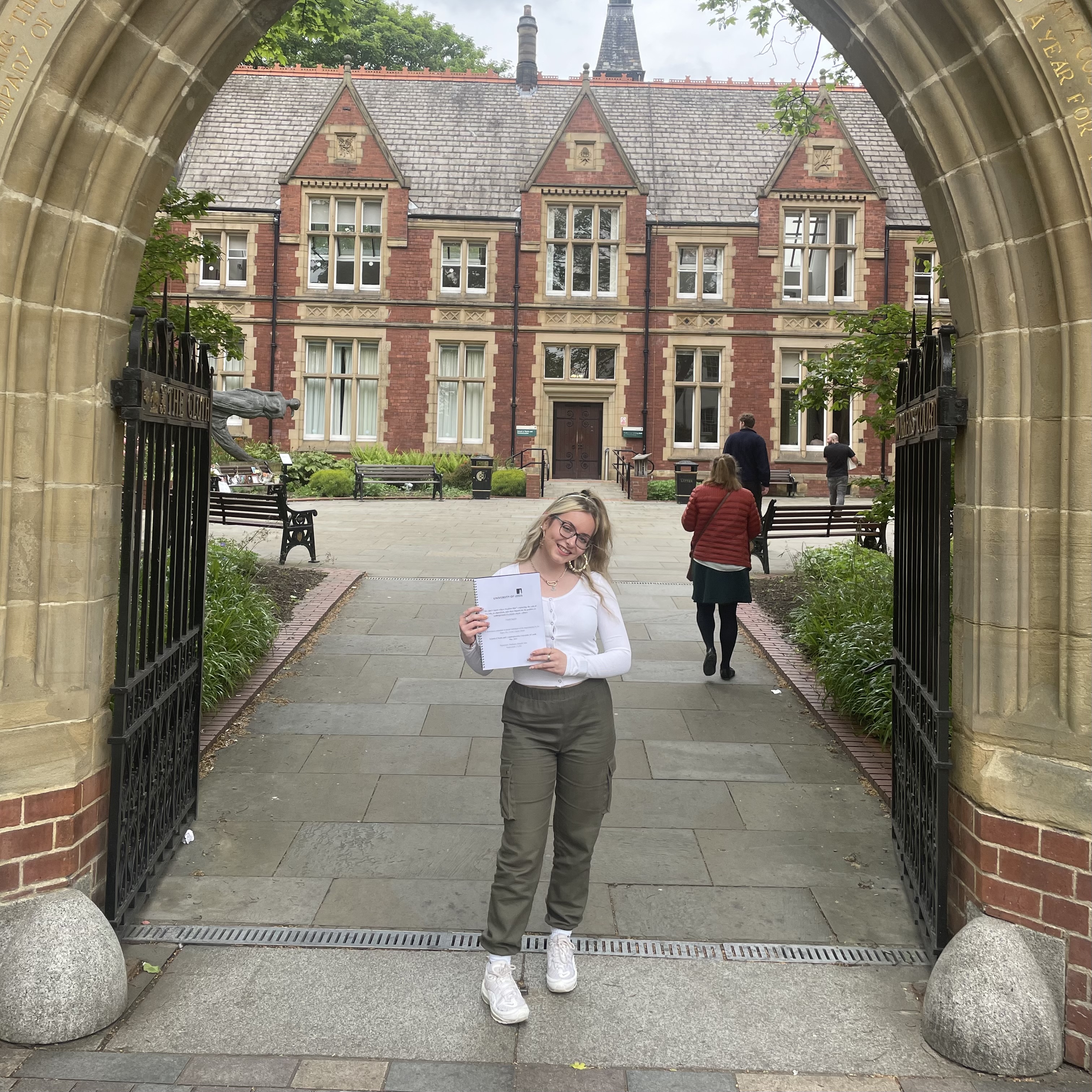 A picture of Niamh holding her BA Dissertation to background the page's description